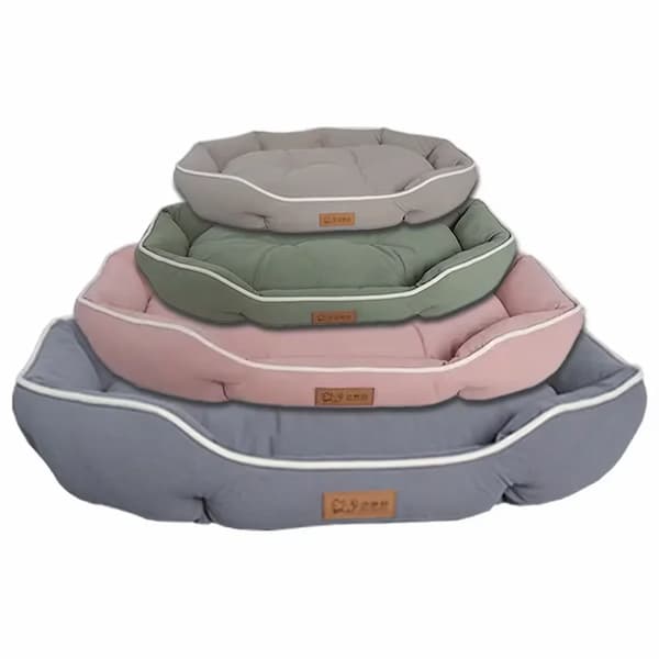 Stack of pet beds in gray, green, and pink on a white background