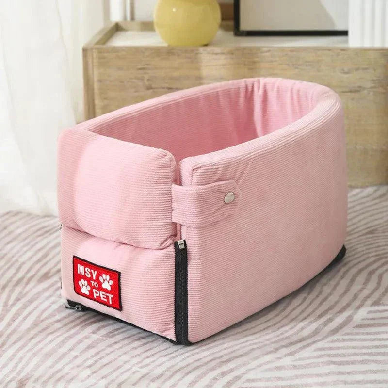 Portable pink dog car seat bed for small pets with cushioned interior, designed for safe car travel.