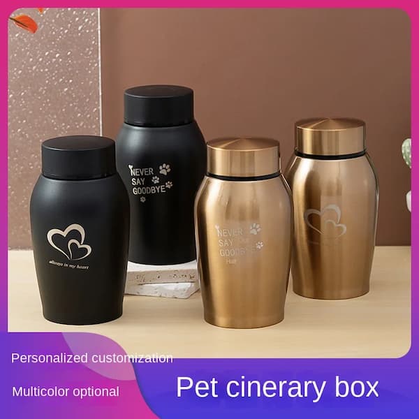 Set of pet cremation urns in black and gold on a neutral background