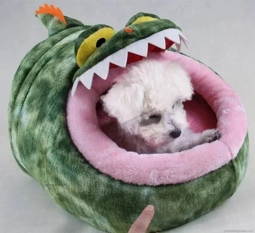 Plush green dinosaur pet bed with pink interior for small animals, featuring a cozy design for warmth and comfort.