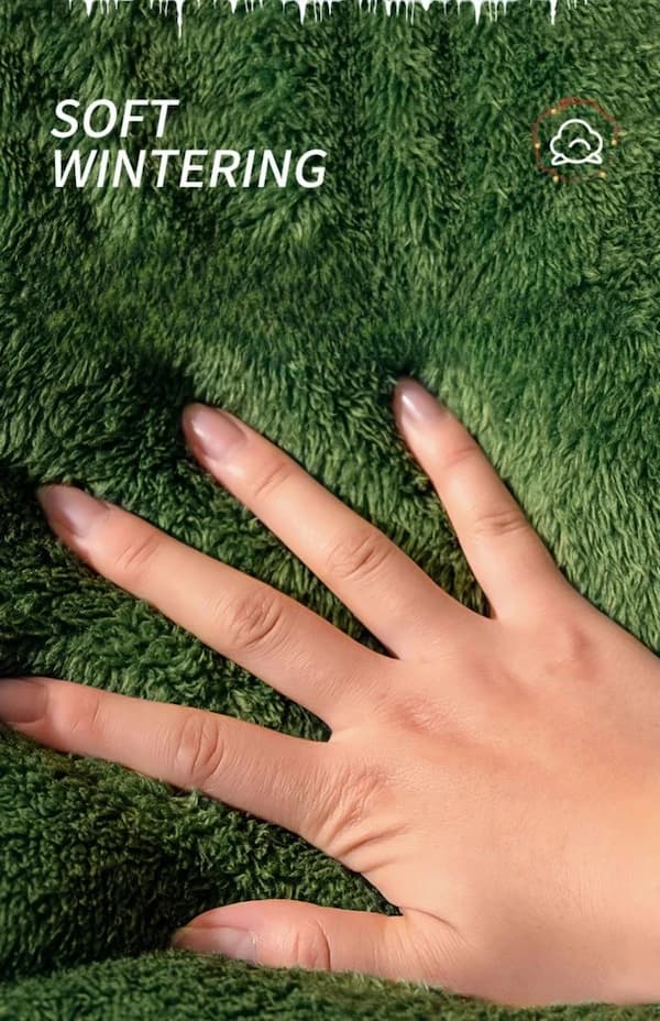 Hand touching soft wintering grass with text overlay