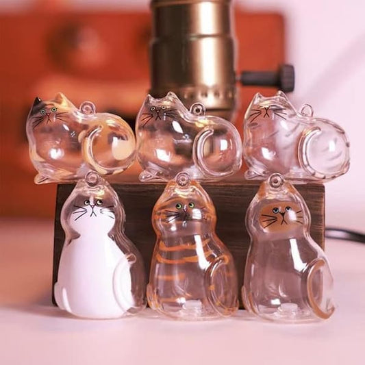 Clear cat-shaped objects with black outlines on a wooden stand.