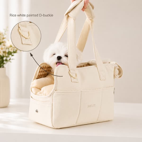 Luxury cream pet carrier bag with padded handles and fluffy white puppy inside designed for comfortable travel with small dogs