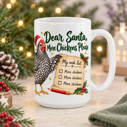 White 15 oz “Dear Santa, More Chickens Please” mug featuring a silver-laced hen and Christmas wish list, styled with winter greenery and fairy lights.