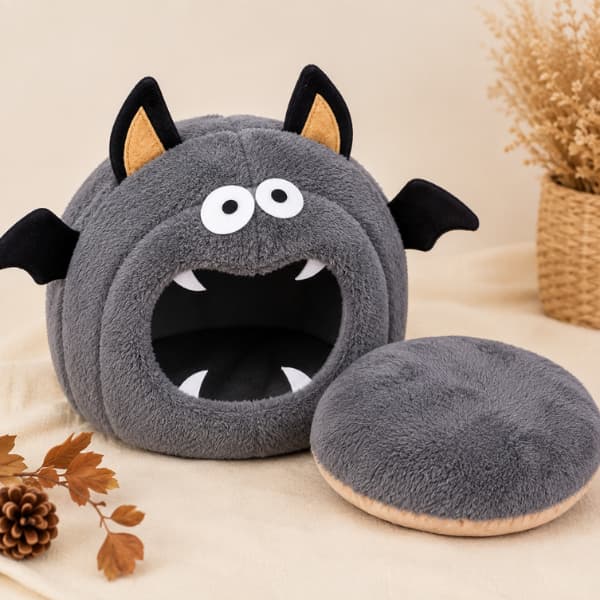 Grey Halloween bat small pet hideaway with removable soft fleece cushion displayed beside the cave bed.