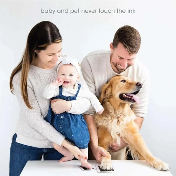 Family creating baby and dog paw print keepsakes using a safe inkless clean touch impression kit