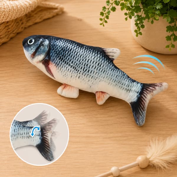 Interactive realistic fish cat toy with moving tail displayed on a wooden table in a cozy indoor setting for cats and kittens