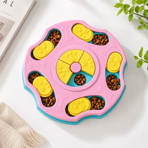 Interactive pet puzzle feeder toy in pastel pink and yellow designed to slow feeding and provide mental stimulation for dogs and cats