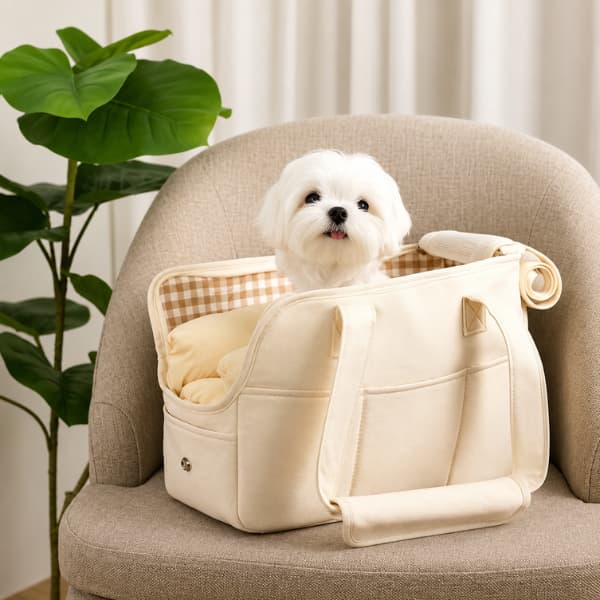 Luxury soft pet carrier bag for small dogs featuring a fluffy white puppy sitting comfortably inside a premium neutral travel carrier