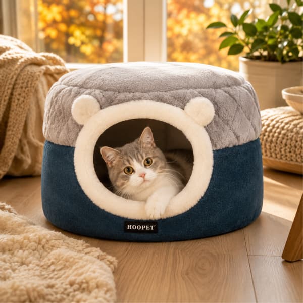 Luxury plush cat cave bed with a cosy cat relaxing in a warm autumn-inspired home, providing a comfortable indoor hideaway for cats and small dogs.