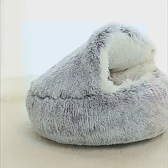 Cozy plush pet bed with a cat nestled inside, designed for small dogs and cats, featuring a soft, round sleeping nest with a cave-style opening.