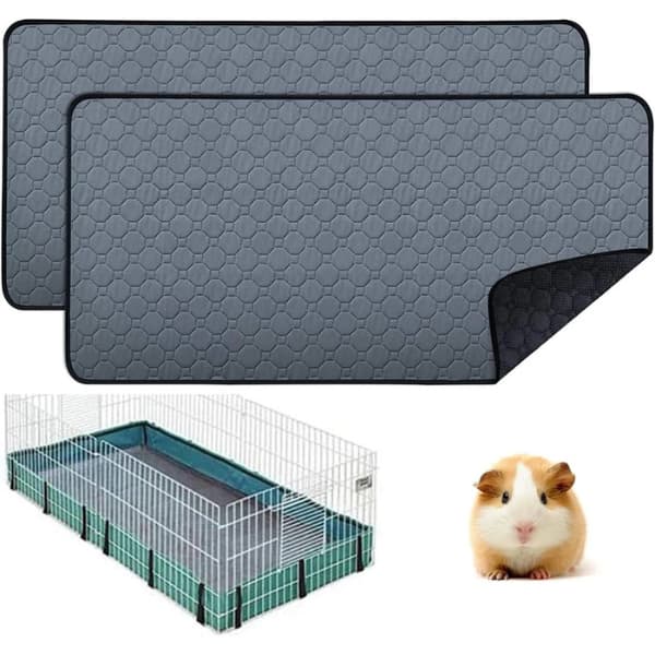 Two gray hexagonal patterned mats with a small animal cage and guinea pig in the background.