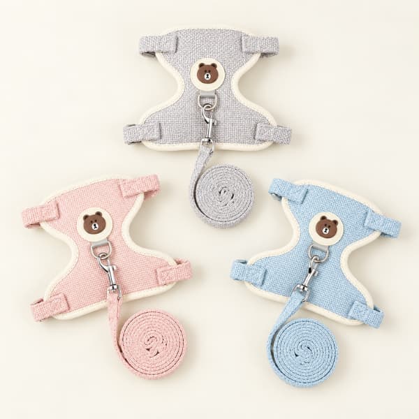 Pink, grey and blue adjustable cat harnesses displayed with their matching leashes.