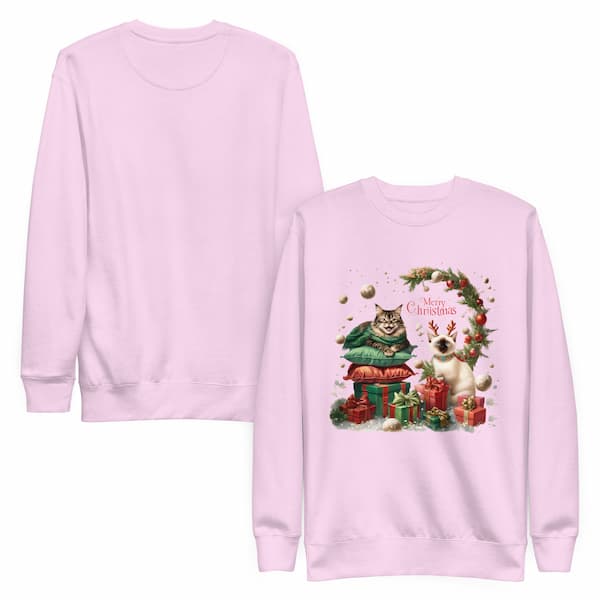 Pink sweatshirt with Christmas-themed design featuring two cats and decorative elements on a white background.