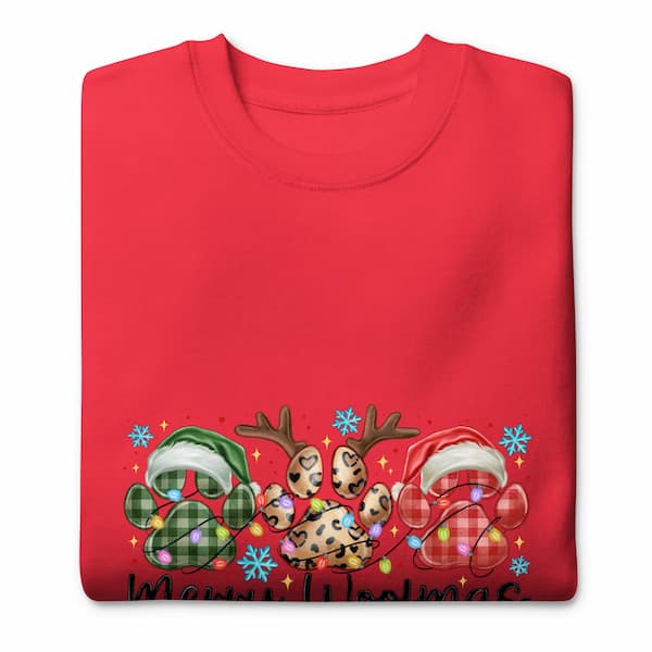 Folded red sweatshirt with Christmas-themed design on a white background