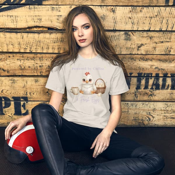 woman wearing Powered by Coffee and Fresh Eggs chicken lover t-shirt with cute backyard chicken illustration