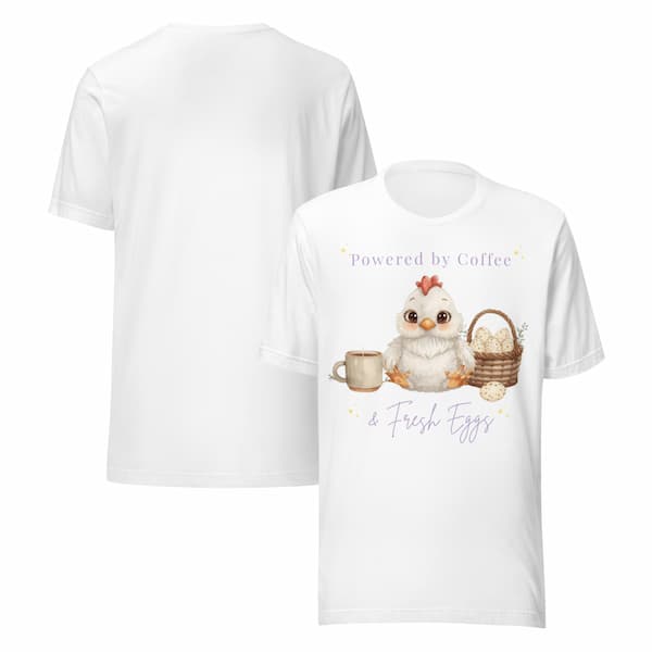 White t-shirt with a cartoon chicken holding a cup and basket, and text 'Powered by Coffee & Fresh Eggs' on a white background.