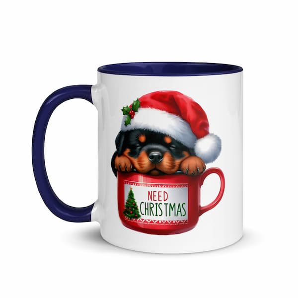 Festive Christmas mug featuring a cute Rottweiler puppy in a Santa hat inside a red cup with Christmas tree design – perfect holiday gift for dog lovers.