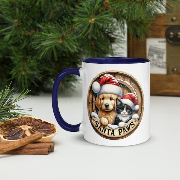 Santa Paws Christmas Mug featuring a cute dog and cat wearing Santa hats inside a wooden wreath design with snowflakes and festive accents.