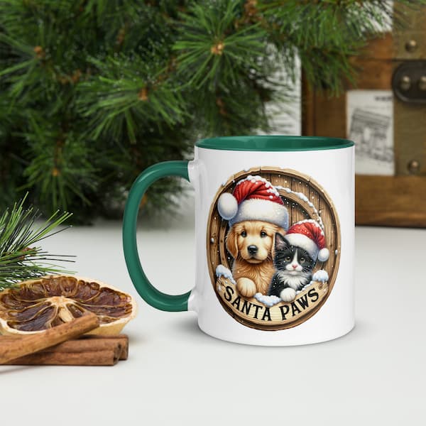 Santa Paws Christmas Mug featuring a cute dog and cat wearing Santa hats inside a wooden wreath design with snowflakes and festive accents.