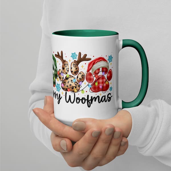 Mug with Christmas-themed design and text held by a person