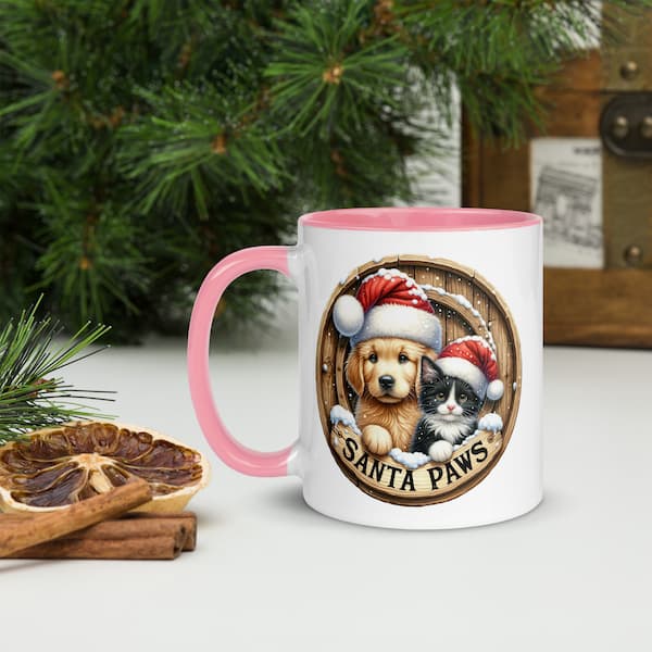 Santa Paws Christmas Mug featuring a cute dog and cat wearing Santa hats inside a wooden wreath design with snowflakes and festive accents.