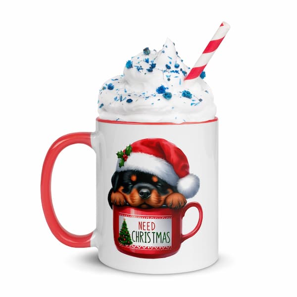 Festive Christmas mug featuring a cute Rottweiler puppy in a Santa hat inside a red cup with Christmas tree design – perfect holiday gift for dog lovers.