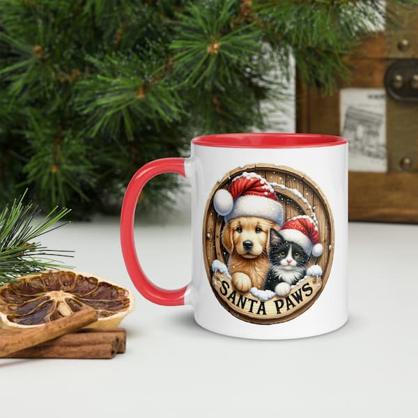 Santa Paws Christmas Mug featuring a cute dog and cat wearing Santa hats inside a wooden wreath design with snowflakes and festive accents.