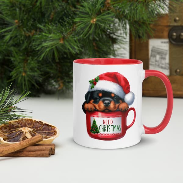 Festive Christmas mug featuring a cute Rottweiler puppy in a Santa hat inside a red cup with Christmas tree design – perfect holiday gift for dog lovers.