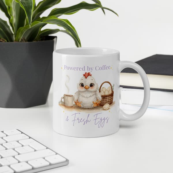 Cute chicken lover coffee mug with “Powered by Coffee & Fresh Eggs” design featuring an adorable hen, coffee cup and egg basket on a white ceramic mug.