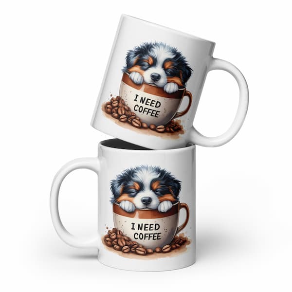 Two mugs with a puppy design and 'I Need Coffee' text on a white background