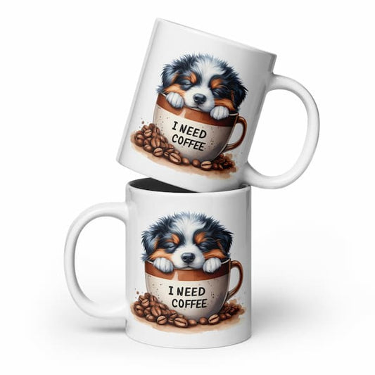 Two mugs with a puppy design and 'I Need Coffee' text on a white background