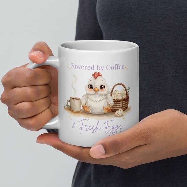 Cute chicken lover coffee mug with “Powered by Coffee & Fresh Eggs” design featuring an adorable hen, coffee cup and egg basket on a white ceramic mug.
